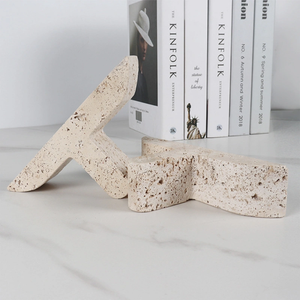 Travertine Stone T Bookends laying on marble table