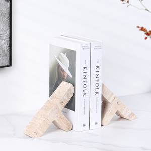 Travertine Stone 'T' Bookends - Sumac Store - kinfolk entrepeneur books with painting on the wall and plant white background on white granite stone table