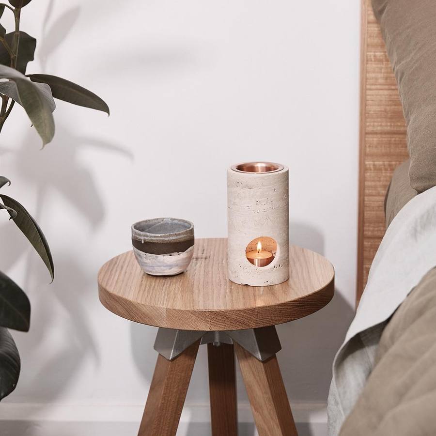 Travertine Stone Oil Burner on a wooden table with a ceramic tea cup bedside with french linen and a plant- Sumac Store